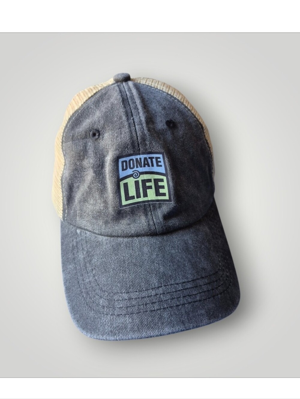 Donate Life Gray and mesh trucker hat with an adjustable closure.